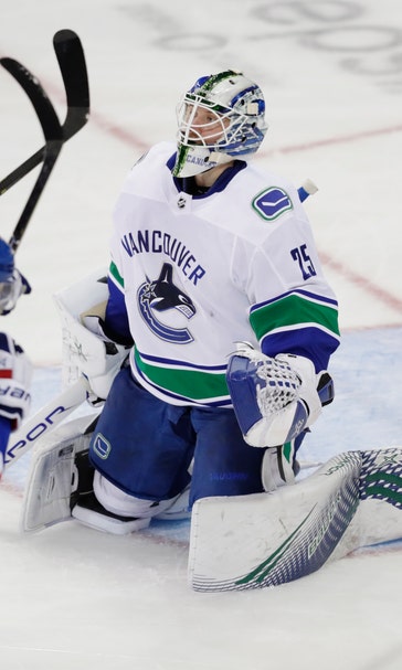 Lundqvist ties Plante on NHL wins list, Rangers edge Canucks